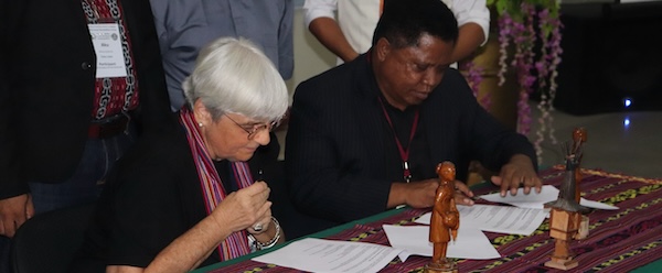 Christine Vertucci and JPIC Executive President of JPIC Fr. Julio Crispim Ximenes Belo signing an MoA